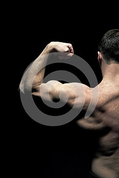 Man athlete with half torso, back view. Sportsman flex arm muscles. Bodybuilder show biceps and triceps. Workout and