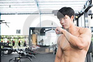 man athlete prepare for training in gym. bodybuilder male working out in fitness center. sport guy doing exercises in health club.