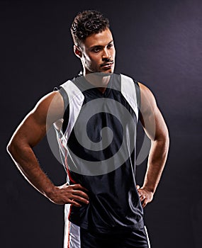 Man, athlete and thinking confidence in studio as basketball player or professional workout, pride or black background
