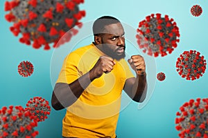 Man attacks with a punch the covid19 coronavirus. Blue background