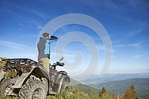 Man on the ATV Quad Bike on the mountains road.