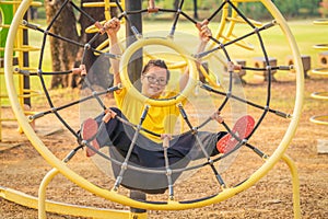 Man with autistic or down syndrome playing at playground in park