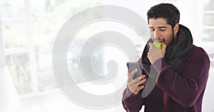 Man in Autumn with apple and phone at bright home