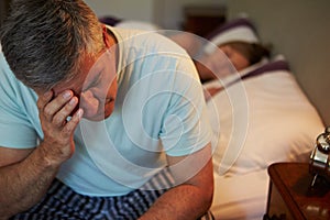 Man Awake In Bed Suffering With Insomnia