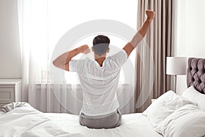 Man awakening on bed at home