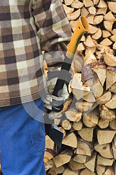 Man with axe and chopped firewood.