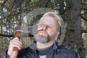 A man with a axe in a forest