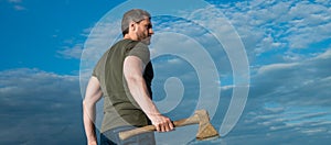 man with axe. woodsman man hold ax. brutal man on sky background