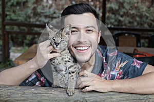Man with baby serval cat