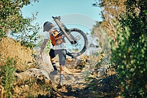 Man, back and carrying bicycle in nature, walking and traveling outdoor in woods. Sports, fitness and male cyclist or