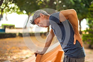 Man with back pain outdoor. Healthcare and medicine concept