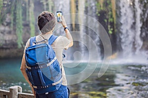 Man on the background of Duden waterfall in Antalya. Famous places of Turkey. Apper Duden Falls