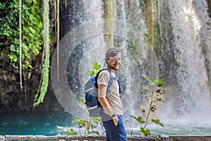 Man on the background of Duden waterfall in Antalya. Famous places of Turkey. Apper Duden Falls