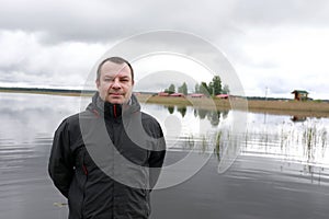 Man on background of Lake Seliger