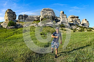 A man on the background of a picturesque view of the Bakhchisarai sphinxes. Bakhchisarai. May 2021