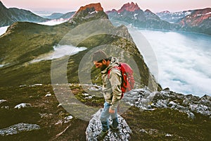 Man with backpack hiking alone in mountains