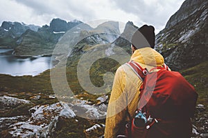 Man with backpack hiking in mountains travel survival alone in wilderness of Norway