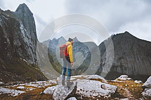 Man with backpack hiking solo in Norway mountains travel vacations outdoor adventure