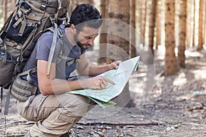 Man with Backpack and map searching directions