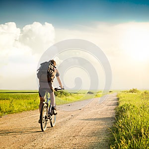 Man with Backpack Riding a Bicycle