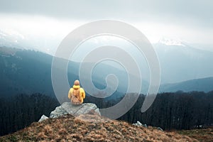 Man with backpack in spring mountains photo