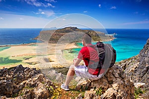 Man with backpack watching beautiful Balos beach on Crete, Greec