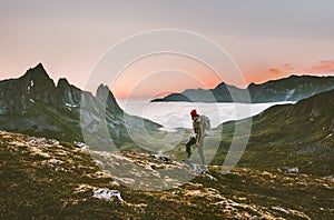 Man backpacker hiking in mountains alone outdoor photo