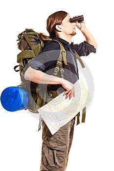 Man backpacker with map looking through binoculars