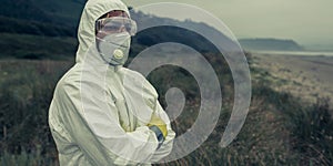 Man in bacteriological protective suit watching the sea