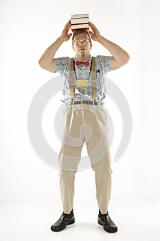 Man balancing books on head.