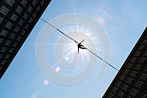 Man balancing on the rope challenge and risk taking concept