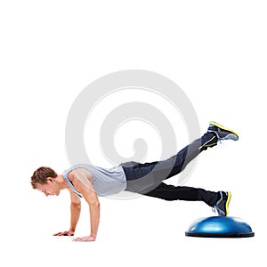 Man, ball and push up or workout in studio, core strength and fitness challenge for wellness. Male person, athlete and