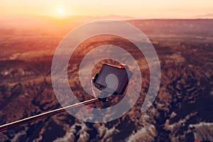 A man in a balloon takes a picture of the landscape of Cappadocia at dawn. Flight in a hot air balloon is one of the