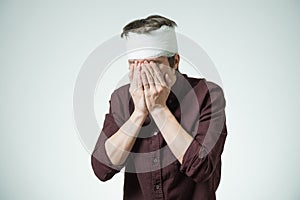 Man with bandage on his head