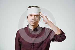 Man with bandage on his head