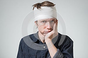 Man with bandage on his head