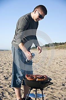 Man and barbecue on beach