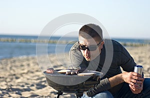 Man and barbecue on beach