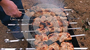 Man barbecuing on the grill, close-up. Barbecue outdoors