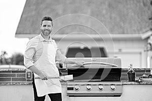 man barbecuing trout fillet, copy space. man barbecuing trout fillet outdoor. man barbecuing photo