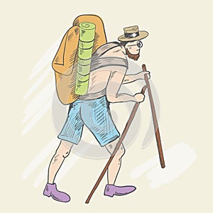 A man with a bare torso, shorts and a heavy backpack rises up the hill.