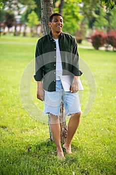 Man barefoot standing near tree in park