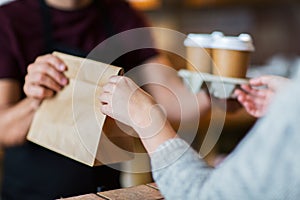 Man or bartender serving customer at coffee shop