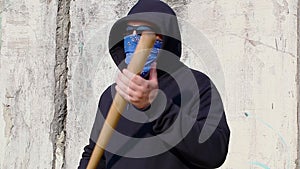 Man with a baseball bat on old wall