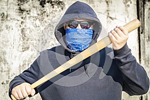 Man with a baseball bat on old wall background