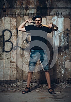 Man with baseball bat on the ruins