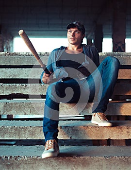 Man with baseball bat on the ruins