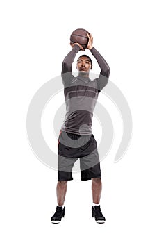 Man, basketball player and shooting for exercise, training and serious on white background, concentration or game