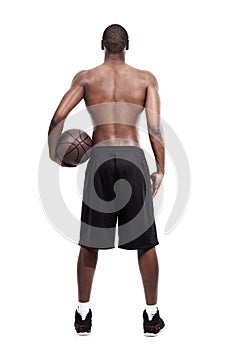 Man, basketball player and standing for training, back and shirtless on white background, confident and game. Studio