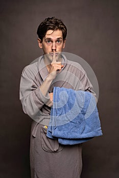 Man with bath towel on grey background